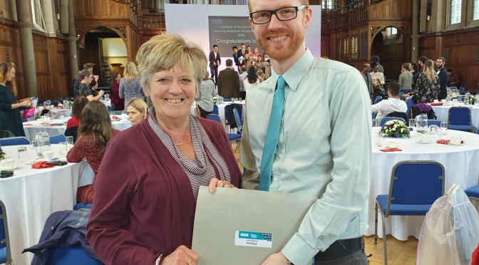 Hilary and Phil holding a certificate