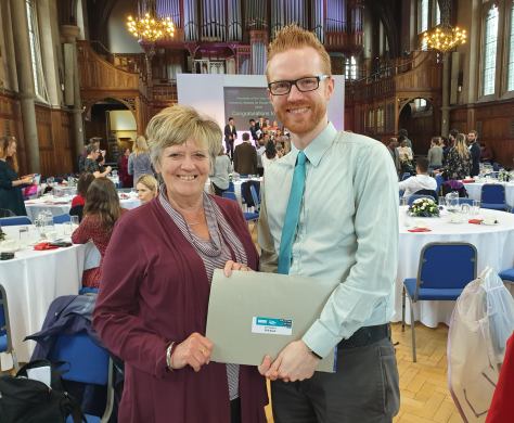 Hilary and Phil holding a certificate