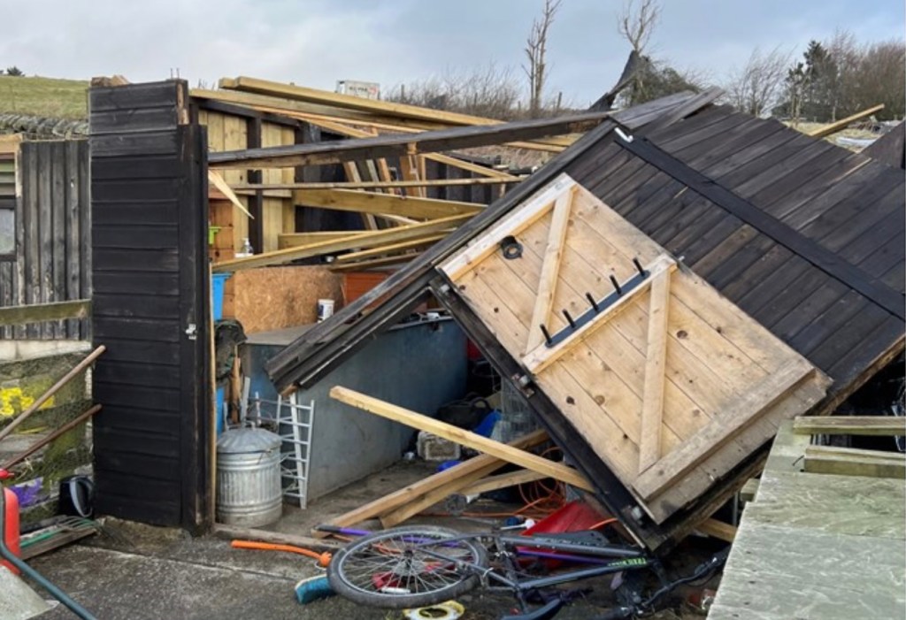 Photograph of wrecked accommodation with broken timbers  collapsed into the building 